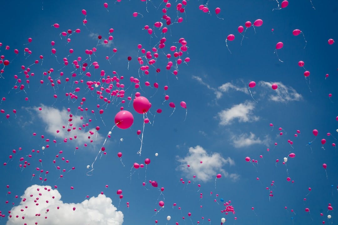 pink balloon lot on air during daytime