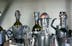 five gray-and-brown metal robots