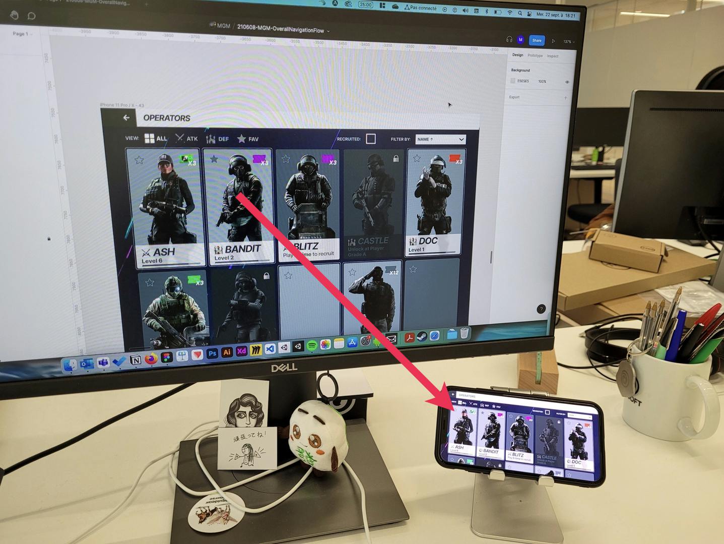 A photo showing a Figma frame on an external HD display being mirrored to a phone.