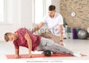 physiotherapist-working-young-male-patient-600w-1177797514.jpg