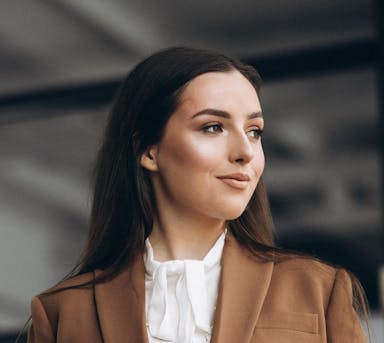 young-business-woman-standing-suit-office-crop.jpg