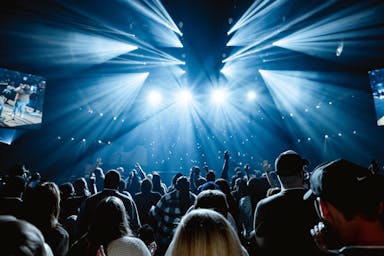 A large crowd of people in a dark room