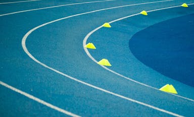 blue curved track field at daytime