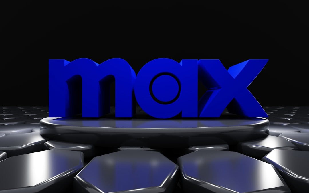 a 3d image of the word max surrounded by hexagonal shapes