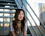 woman sitting on white metal stairs