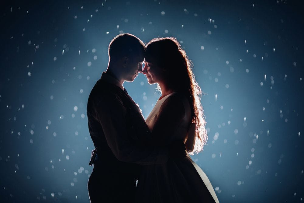 stock-photo-romantic-just-married-couple-hugging-face-face-against-illuminated-dark-background-with-glowing-sparkles-around.jpg