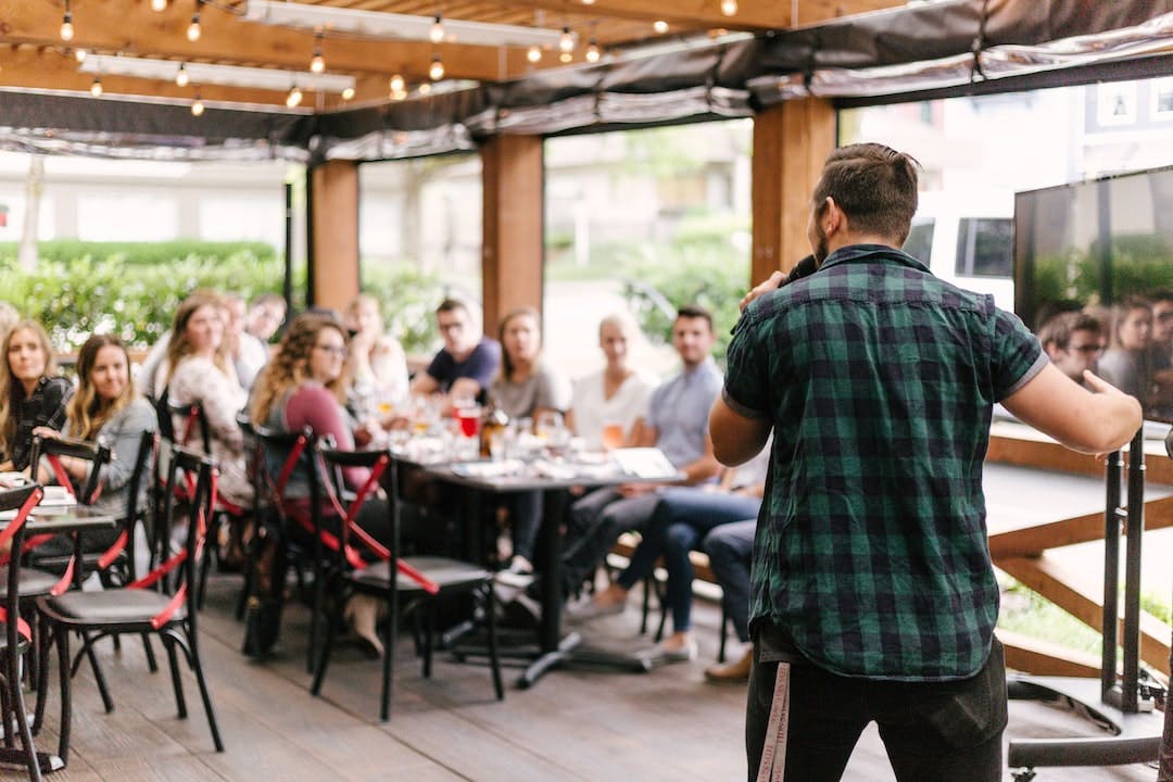 man standing infront of group of people