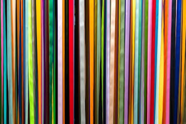 a large group of multicolored sticks in a room