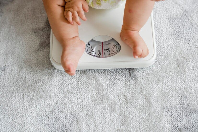 closeup-baby-s-legs-weighing-scale_53876-137645.jpg