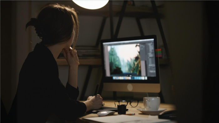 An image of a woman editing a photo on PC