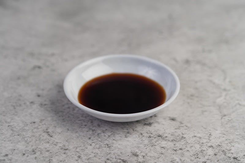 black-sauce-small-white-cup-placed-cement-floor.jpg